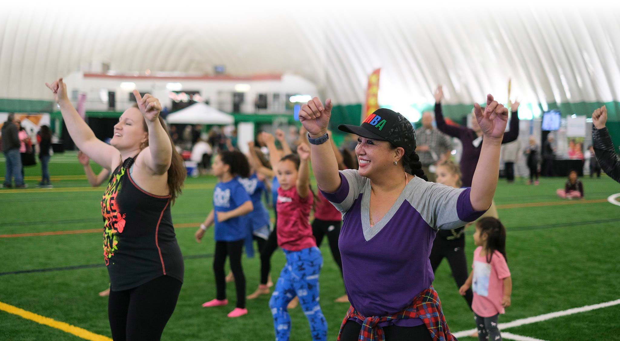Group of people of various ages inside The Dome exercising